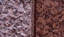 Granite on the outside wall of The Gallery. Rough “flamed” texture left; polished surface right