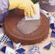Spreading mortar onto a wet stone