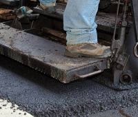 Machine Paving a New Asphalt Driveway